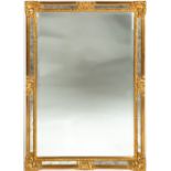A MODERN RECTANGULAR GILT FRAMED WALL MIRROR with mirrored slips around the bevelled glass, 95cm