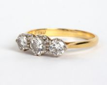 AN 18 CARAT GOLD THREE STONE DIAMOND RING by F E U, 2.9 grams in total At present, there is no