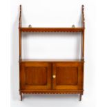 A VICTORIAN MAHOGANY HANGING WALL SHELF with twin panelled cupboard door, 52.4cm wide x 13cm deep