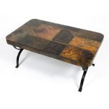 A TILE AND BRASS COFFEE TABLE with a wrought iron base, 100cm wide x 60cm deep x 44cm high