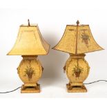 A PAIR OF TOLEWARE TABLE LAMPS of urn form with lion ring handles and paw feet, each 30cm wide x
