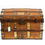 A LATE 19TH CENTURY AMERICAN DOME TOPPED TRUNK with leather handles and brass mounts, 84cm wide x