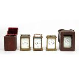 FOUR LATE 19TH / EARLY 20TH CENTURY GLASS CARRIAGE TIMEPIECES all with enamelled dials and roman