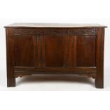 AN ANTIQUE OAK COFFER the twin plank top with cleated ends, the triple panel front with chip