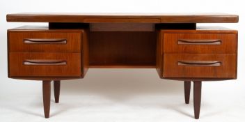 A MID TO LATE 20TH CENTURY G PLAN TEAK DRESSING TABLE with a mirrored back, central narrow drawer