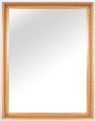 A LATE 20TH CENTURY GILDED RECTANGULAR WALL MIRROR with bevelled glass, 106cm wide x 136cm high