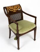 A MAHOGANY OPEN ARMCHAIR with caned seat and back having gilded decoration, square tapering legs and