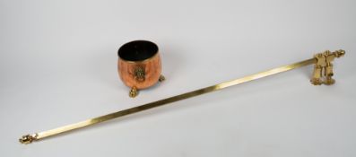 A 19TH CENTURY COPPER AND BRASS JARDINIERE with lion's mask ring handles and three paw feet, 25cm