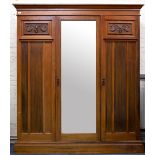 AN EARLY 20TH CENTURY WALNUT MAPLE & CO TRIPLE WARDROBE with central mirrored door and with