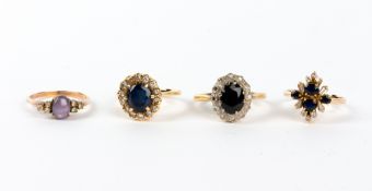 A SAPPHIRE AND WHITE STONE INSET YELLOW METAL CLUSTER RING marked 14K; a sapphire and diamond 18