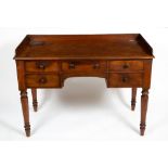 AN EARLY VICTORIAN MAHOGANY SIDE TABLE OR DESK with a galleried back, five drawers and turned