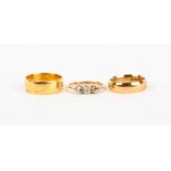 AN 18 CARAT GOLD THREE STONE DIAMOND RING 2 grams in weight; a 9 carat gold wedding band, 6.4