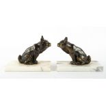 A PAIR OF MARBLE AND SPELTER BOOKENDS in the form of mythical beasts, each 13cm wide x 9.5cm high