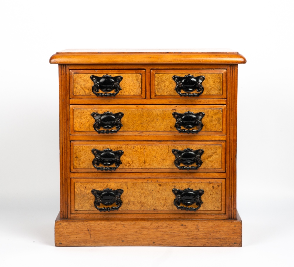 A WALNUT TABLE TOP MINIATURE CHEST OF TWO SHORT AND THREE LONG DRAWERS with burr walnut veneered