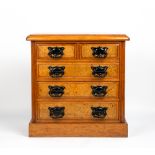 A WALNUT TABLE TOP MINIATURE CHEST OF TWO SHORT AND THREE LONG DRAWERS with burr walnut veneered