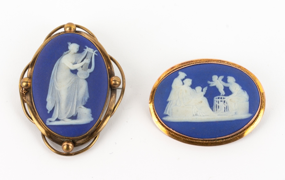 TWO 19TH CENTURY WEDGWOOD JASPERWARE BROOCHES with yellow metal mounts, one marked 9 carat, the