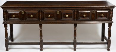 AN ANTIQUE 17TH CENTURY STYLE OAK DRESSER BASE with three drawers having mitre moulded fronts and