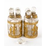 A PAIR OF 19TH CENTURY CONTINENTAL EMPIRE STYLE GILT ORMOLU MOUNTED SETS OF FOUR SCENT BOTTLES