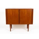 A 1960'S / 70'S TEAK SIDE CABINET with sliding doors, adjustable shelves and turned legs, 85.5cm