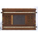 AN OAK WALL HANGING SNOOKER CUE BOARD by Orme & Sons Manchester, London and Glasgow, with central