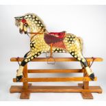 AN EARLY 20TH CENTURY PAINTED PLASTER AND WOOD ROCKING HORSE mounted on a pine frame, overall