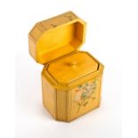 A GEORGE III STYLE YELLOW PAINTED OCTAGONAL TEA CADDY with floral decoration, 12cm wide x 9cm deep x