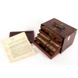 AN EARLY 20TH CENTURY BONE AND BAMBOO MAHJONG SET in a brass and hardwood mounted six drawer