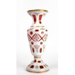 A BOHEMIAN CRANBERRY AND WHITE LAYERED GLASS VASE 25cm in height Condition: very minor wear to the