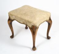 AN EARLY 20TH CENTURY UPHOLSTERED WALNUT FRAMED STOOL with cabriole legs, 46cm wide x 43cm deep x