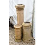 A GROUP OF THREE BUFF TERRACOTTA CHIMNEY POTS the largest marked Doulton Condition: weathered
