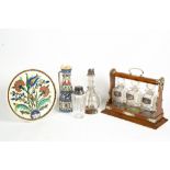 A VICTORIAN OAK AND SILVER PLATE TANTALUS with three cut glass bottles and three silver spirit