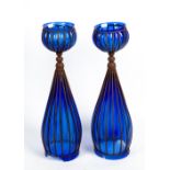 A PAIR OF IRON WORK AND BLUE GLASS FLOOR STANDING VASES the globular tops with large bases, each