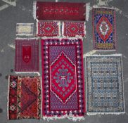 NINE RUGS to include a Tunisian pink ground rug, 105cm x 205cm together with Middle Eastern rugs and