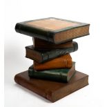 A PAINTED HARDWOOD TABLE in the form of a stack of books, 34cm wide x 31cm deep x 40cm high At