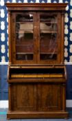 A VICTORIAN MAHOGANY CYLINDER BUREAU BOOKCASE with twin glazed doors and column supports above