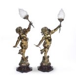 After Eutrope Bouret (1833-1906) Pair of gilt metal cupid lamps, each on a marble base, with