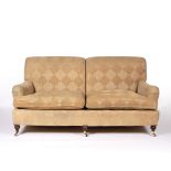 In the Manner of George Smith Two seater sofa on mahogany supports with brass castors, 185cm across,