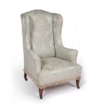 Mahogany framed wingback armchair on short square supports with original castors, 116cm high, 77cm