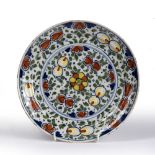 Delft dish decorated in polychrome colours depicting flowers, 22.5cm across