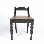 Anglo/ Indian ebony low chair 19th Century, carved to the back and on the front supports, 49cm