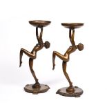 Pair of Art Deco metal stands each in the form of a maiden with arms outstretched, 37cm high