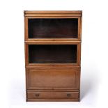 Globe Wernicke style three tier bookcase mahogany, two glazed sections over a cupboard and a drawer,