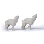 Two Royal Worcester dogs with stamps to the legs, glazed, unpainted, 7.5cm high (2)