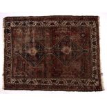 Persian red ground rug with joined central double medallion and with foliate border, 146cm x 112cm
