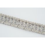 Diamond set panel bracelet designed as a line of articulated openwork panels with central star