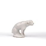 Delft model of a hound 18th Century, in white tin-glaze seated on a mound base, the docked tail