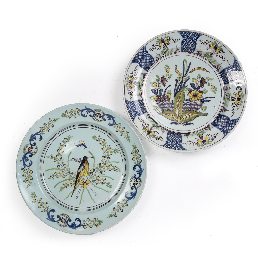 Two Delftware polychrome chargers circa 1740, one painted with a bird and butterfly, 35cm and the