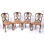 Set of four dining chairs Victorian, with pierced scrolling vase shaped splat and overstuffed