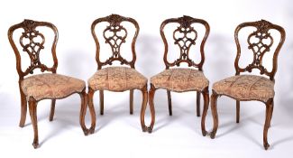Set of four dining chairs Victorian, with pierced scrolling vase shaped splat and overstuffed