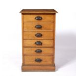 Set of six graduated drawers with brass handles on plinth base, oak, 48cm wide x 82cm high x 34cm